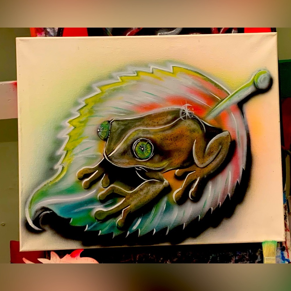 A 16x20 inch canvas of an airbrush, El Coquí on a leaf enjoying life’s beauty.